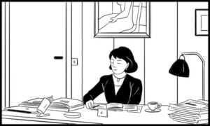 A woman sitting at a desk, reading papers, with books and a cup of coffee in front of her.